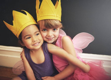 Photo for Children, cute and costumes in portrait with hug for friendship, smile and dress up in fairy clothes for fun. Girls, play and love for diversity, happiness and princess with wings for embracing. - Royalty Free Image