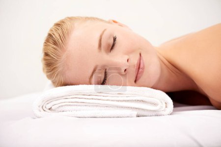 Photo for Relax, sleep and woman at spa with towel for luxury holistic treatment, facial health and professional massage therapy. Self care, peace and refresh for girl on bed with body wellness, rest and hotel. - Royalty Free Image
