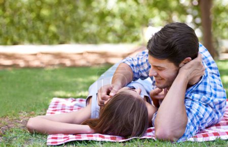 Photo for Love, picnic and couple on blanket at the park on a romantic date and lying on grass. Summer, happy partners and relax on vacation, anniversary or outdoor in nature sunshine for valentines day. - Royalty Free Image