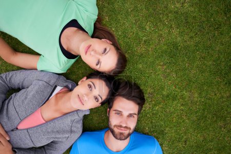 Photo for Top view, group of people on grass and portrait for fitness, relax after workout for health and wellness together. Exercise, training club for sports and active in nature, support and trust outdoor. - Royalty Free Image