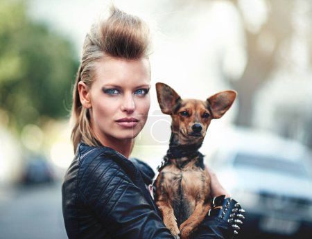 Photo for Woman, portrait and punk fashion with pet, edgy and rock n roll for cool in funky clothes and care for chihuahua dog. London, person and face in leather jacket in town and love for domestic animal. - Royalty Free Image