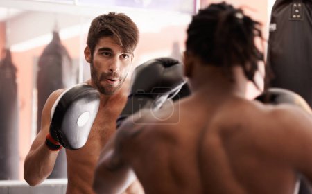 Photo for Men, coach and mixed martial arts with punch in fight, gloves and pad for fitness in gym together. People, combat and action for mma, boxing or hands for power, workout and exercise for competition. - Royalty Free Image