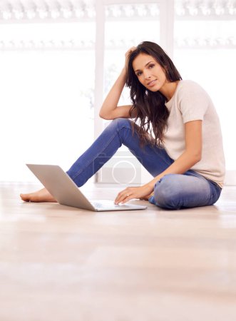 Photo for Portrait, laptop and research with woman on floor of living room in home for email, internet or information. Computer, relax and social media with serious young person in apartment for browsing. - Royalty Free Image