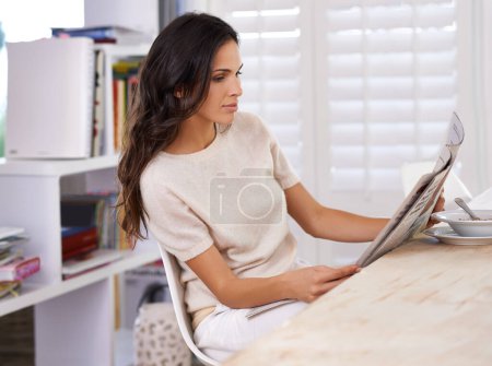 Photo for Woman, reading and newspaper at breakfast in home for information, update or global headlines in morning. Person, girl and newsletter for media, finance and article with international story in house. - Royalty Free Image