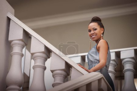 Photo for Woman, portrait and staircase with dress for gala event and party with confidence and fashion. Wealth, classy and elegant with expensive, fancy and rich clothes with African female person at mansion. - Royalty Free Image