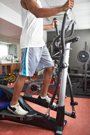 Fitness, legs and air walker with man in gym for health, wellness or workout to improve cardio. Exercise, running and sports with athlete on glider machine for endurance . training as marathon runner.