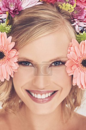 Photo for Woman, portrait and flowers on crown for beauty, happiness and wellness with spring aesthetic and floral art. Model, face and cosmetics with carnation plants for facial glow, skincare and headband. - Royalty Free Image
