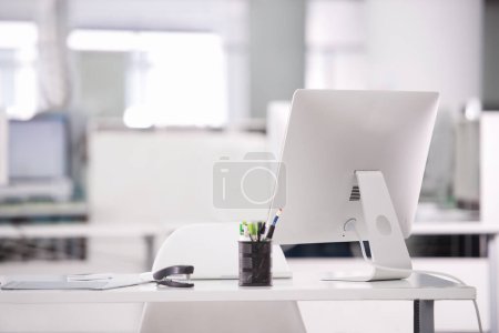 Photo for Empty office, computer and business interior on desk, company furniture and workspace. Vacant workplace, corporate setup and technology on table, professional design and detail at modern agency. - Royalty Free Image