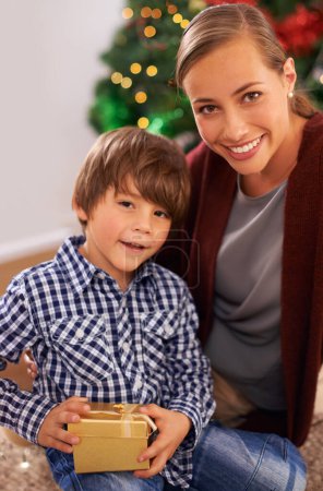 Photo for Child, mother and portrait with Christmas present for festive season celebration for bonding, giving or holiday. Female person, boy and gift box in Canada at tree for vacation, happiness or package. - Royalty Free Image
