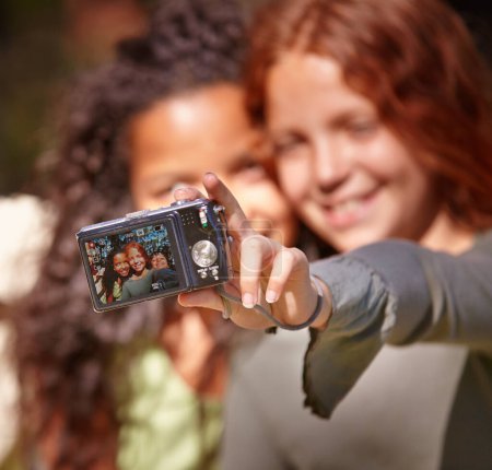 Photo for Happy girl, friends and selfie with camera in nature for memory or outdoor photography together. Young female person, child or kid with smile for picture, photo or social media in relax or friendship. - Royalty Free Image