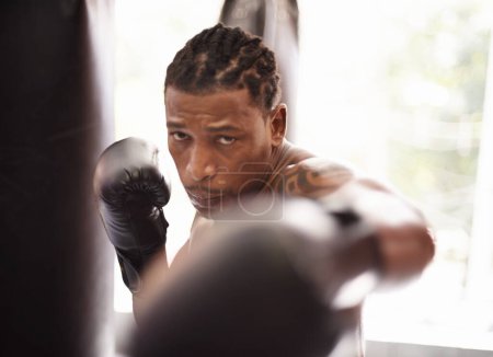 Photo for Punch, portrait and black man with boxing gloves in gym for fitness challenge, fight and competition training. Power, fist and serious face of champion boxer at workout with confidence in sports club. - Royalty Free Image