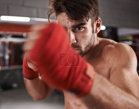 Photo for Man, fist and ready for fighting in gym, fitness and topless for exercise and workout. Male person, bodybuilder and punching for challenge or practice, training and martial arts for competition. - Royalty Free Image