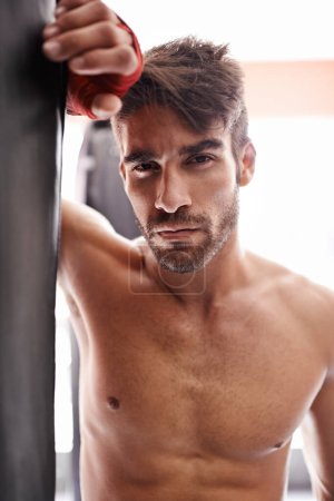 Photo for Man, portrait and boxer in gym for fitness, training and determination with gloves for match. Male athlete, mma and fighter at combat studio for practicing for competition, challenge and kickboxing. - Royalty Free Image