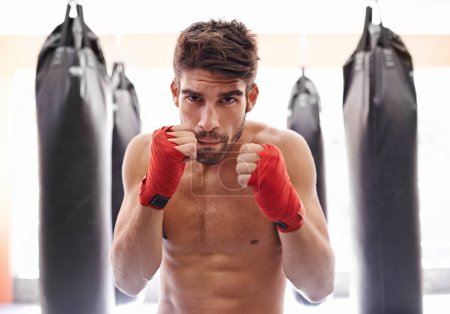 Photo for Boxer, gym and portrait for fitness, exercise and wellness in strong training for confidence to fight. Man, sport and boxing athlete in training, challenge and shirtless ready to punch for kickboxing. - Royalty Free Image