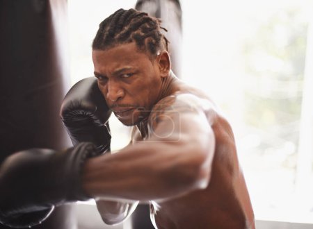 Téléchargez les photos : Bataille, portrait et homme noir avec des gants de boxe dans la salle de gym pour le défi, le combat et l'entraînement de compétition. Puissance, muscle et visage sérieux du boxeur champion à l'entraînement avec confiance dans le club de sport - en image libre de droit