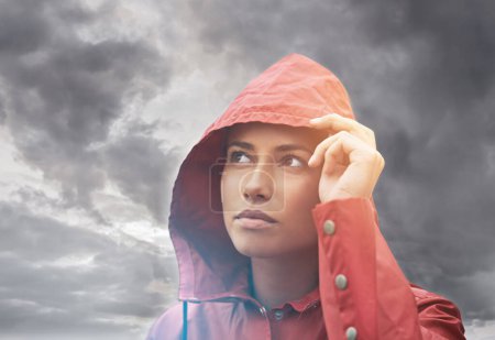 Photo for Rain coat, woman and clouds with weather, outdoor and freedom with break and traveling. Person, winter or girl with cover or carefree with overcast and storm with fog or wet with water and nature. - Royalty Free Image