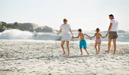 Photo for Parents, children and hand holding on beach for travel together at ocean for trip connection, bonding or love. Man, woman and siblings with back view at sea in Florida for vacation, outdoor or family. - Royalty Free Image