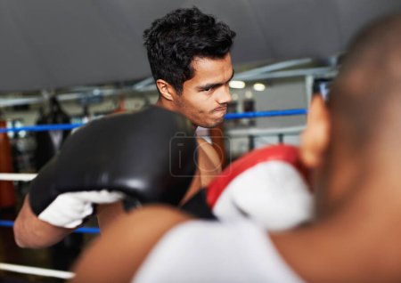 Photo for Boxer, man and fight in boxing ring for training, workout and confidence for performance with coach and fitness. Professional, athlete and exercise for competition, match and sport with endurance. - Royalty Free Image