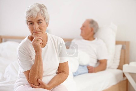 Photo for Senior, couple and sad in bedroom with conflict, ignore and crisis in marriage for mental health or retirement. Elderly, woman or man with fight, argument or divorce on bed in home with disagreement. - Royalty Free Image
