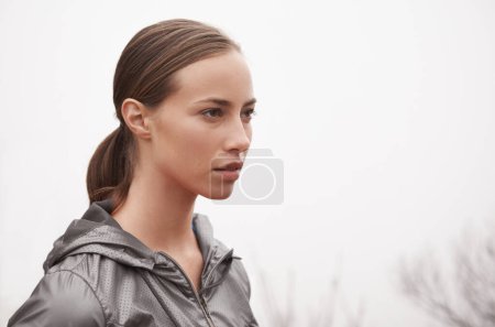 Photo for Woman, face and fitness outdoor with fog for hiking, exercise and workout in nature with confidence. Athlete, person and mockup space with pride for running, training and sportswear for healthy body. - Royalty Free Image