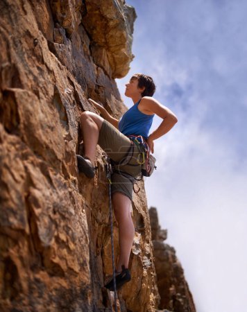 Photo for Rock climbing, woman and fitness with adventure, rope and gear in nature on a mountain. Cliff, hiking and sport with athlete challenge and thinking for workout, exercise and climber training outdoor. - Royalty Free Image