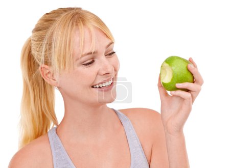 Photo for Bite, smile and woman with apple for diet, benefits or food to lose weight in studio. Healthy eating, nutrition and happy face of girl with fruit for body wellness, digestion and white background. - Royalty Free Image
