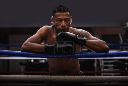 Photo for Portrait, exercise and black man boxer in ring at gym for combat sports training or competition. Fitness, boxing or fighting with shirtless young athlete on break from intense self defense workout. - Royalty Free Image