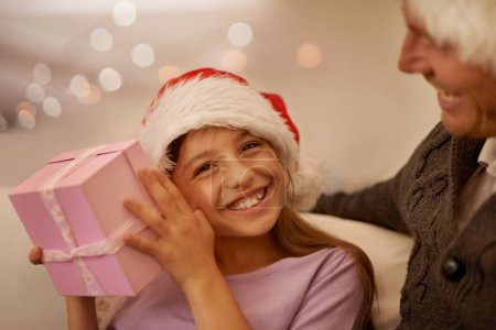 Photo for Christmas, sofa and portrait of child with gift box, dad and celebration together with happy surprise. Holiday, father and daughter smile on couch for present giving, festive xmas and love in home - Royalty Free Image