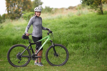Photo for Portrait, smile for cycling and woman in countryside with bike for off road training, cardio or hobby. Exercise, fitness or sports and happy young athlete or cyclist in nature with helmet for workout. - Royalty Free Image