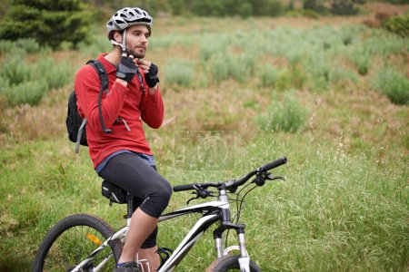 Photo for Fitness, bike and man cycling with helmet for adventure, discovery or off road sports hobby. Exercise, health and safety with young cyclist on bicycle in countryside for cardio training or workout. - Royalty Free Image