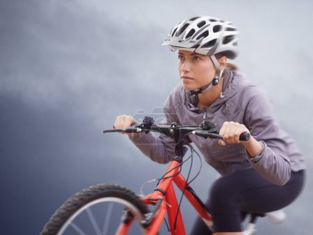 Photo for Woman, bike and nature with cycling, speed and fitness for health and wellness or workout. Athlete, ride and exercise for training, transportation and adventure with helmet and cardio or confidence. - Royalty Free Image