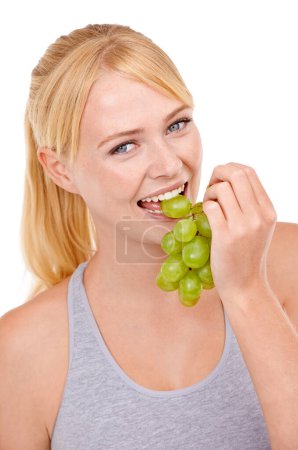 Photo for Studio, woman and portrait with eating grapes for vitamin c, vegan and diet for wellness. Food, face and happy person with fruit for detox, gut health and nutrition benefits on white background. - Royalty Free Image