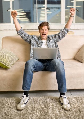 Photo for Wow, portrait and happy man with laptop celebration on a sofa for online competition success at home. Excited, face and male winner in living room with pc alert for giveaway, prize or sign up reward. - Royalty Free Image