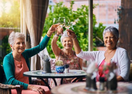Photo for Cheers, wine and portrait with old women in restaurant for bonding, lunch and relax. Retirement, hospitality and happiness with senior friends with drink for social celebration, memory and support. - Royalty Free Image
