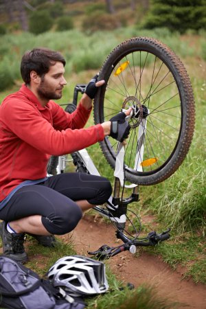 Photo for Exercise, bicycle and fixing wheel with man cyclist in countryside for sports, hobby or cardio training. Fitness, cycling or tyre puncture with young athlete and bike outdoor in nature for workout. - Royalty Free Image