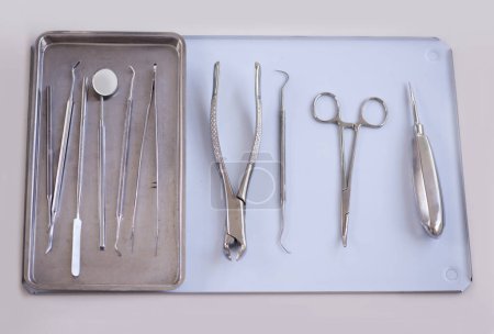 Photo for Top view of tools for dentist, steel and dental for healthcare, procedure or treatment with orthodontics. Oral hygiene, medical equipment for teeth and tray with instruments for dentistry and surgery. - Royalty Free Image