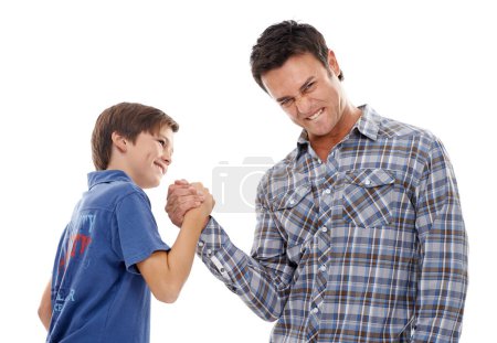 Father, portrait and arm wrestle with child for game of strength, power or playful bonding on a white studio background. Dad, son or kid with handshake in battle for challenge, parenting or childhood.