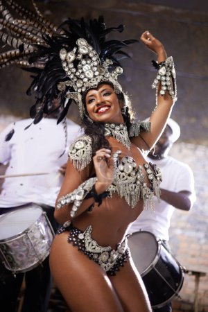 Photo for Carnival, dancing and woman for performance in Brazil, dancer with gemstone outfit and feather head gear outdoor. Music, samba and happiness for event, culture with festival entertainment and talent. - Royalty Free Image