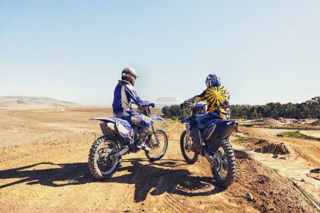 Photo for Rear view, racer or people on motorcycle outdoor on dirt road with relax after driving, challenge and competition. Motocross, motorbike and dirtbike driver with helmet on offroad and path for racing. - Royalty Free Image