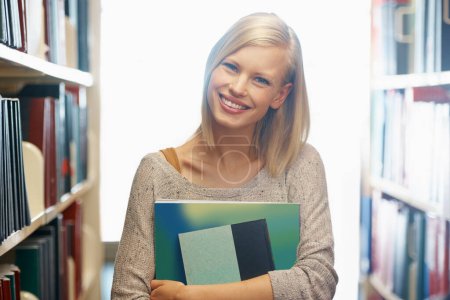 Photo for Woman, library and book, portrait with story for education and knowledge with smile on campus. Student, bookstore and reading material for learning, happy with university and academic development. - Royalty Free Image