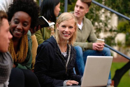 Photo for Woman, university student with laptop and outdoor on campus, smile and research to study for exams. Diverse group, college and information for learning and share notes for test or assignment deadline. - Royalty Free Image