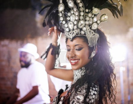 Dancer, carnival and girl with performance, band or pride for culture in group, music or concert in night. Woman, smile and people dancing at event, party or celebration for show in Rio de Janeiro.