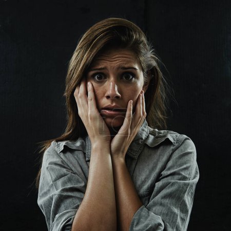 Photo for Portrait, stress and horror with phobia woman in studio on black background for reaction to fear. Face, anxiety and mental health with scared young person in dark for drama, nightmare or terror. - Royalty Free Image