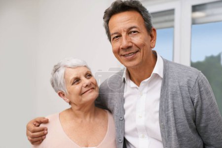 Photo for Portrait, senior or happy couple hug in lounge at home for bonding together with support, pride or smile. Retirement, people or romantic man by an elderly woman for peace, love or care in marriage. - Royalty Free Image