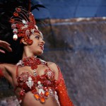 Samba, carnival or happy woman in costume for event, music culture or night celebration in Brazil. Outdoor, performance or proud dancer with smile at festival party, parade or show in Rio de Janeiro.