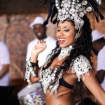 Dancer, carnival and woman with band, happy and pride for culture with group for music performance in night. Girl, men and people dancing at event, party or celebration for history in Rio de Janeiro.