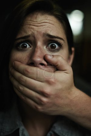 Photo for Woman, portrait and hand for kidnapping or scared victim for danger crime or terror anxiety, terrified or stalking. Female person, mouth and fingers of criminal in America or panic, fear or hostage. - Royalty Free Image