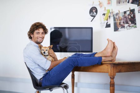 Photo for Happy man, computer screen or portrait with dog for work or technology mock up for online publisher in agency. Young guy, face or desktop for company with pet or feet on table to relax with chihuahua. - Royalty Free Image