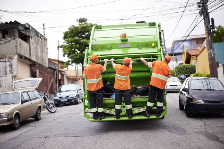 Photo for Industry, waste management and garbage truck with men in uniform cleaning outdoor on city street. Job, service and male people working with rubbish for sanitation, maintenance or collection of dirt - Royalty Free Image