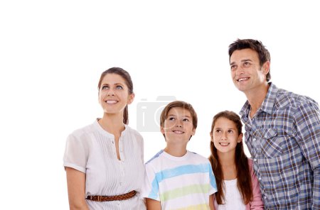 Photo for Mother, father and children on a white background looking up for bonding, relationship and mockup space. Family, love and isolated mom, dad and kids for news, information and announcement in studio. - Royalty Free Image